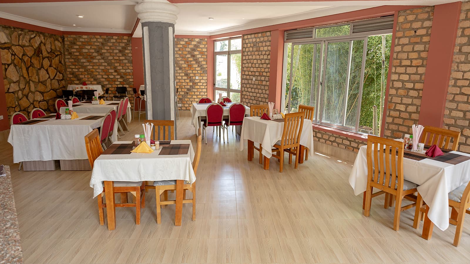 The dining room at Hotel Premier, built from local stone with the garden alongside